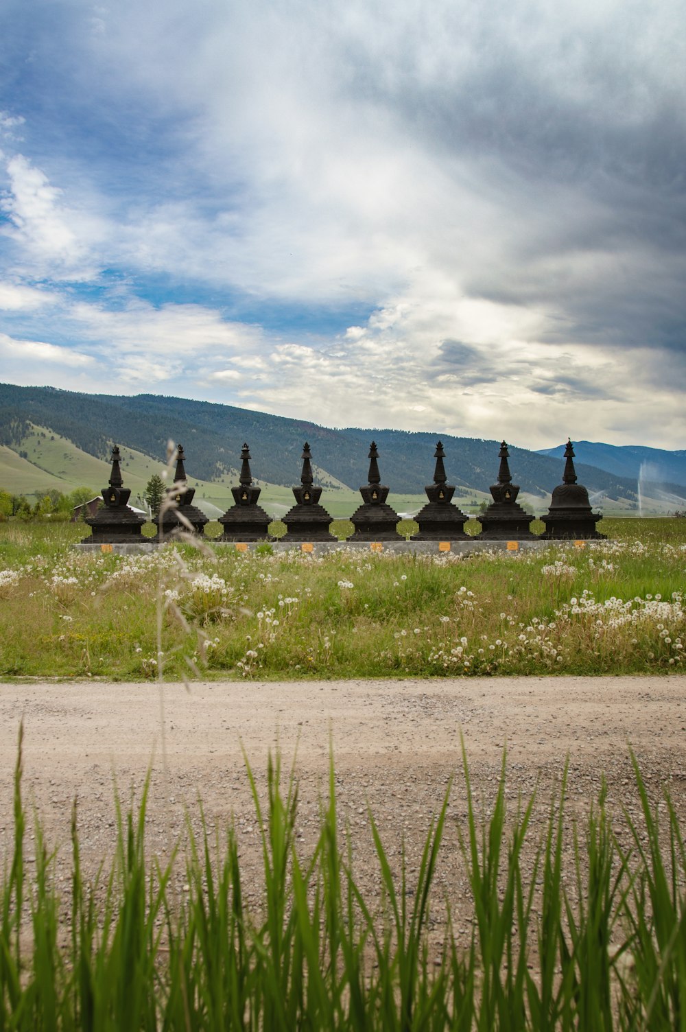 a bunch of statues sitting in the middle of a field