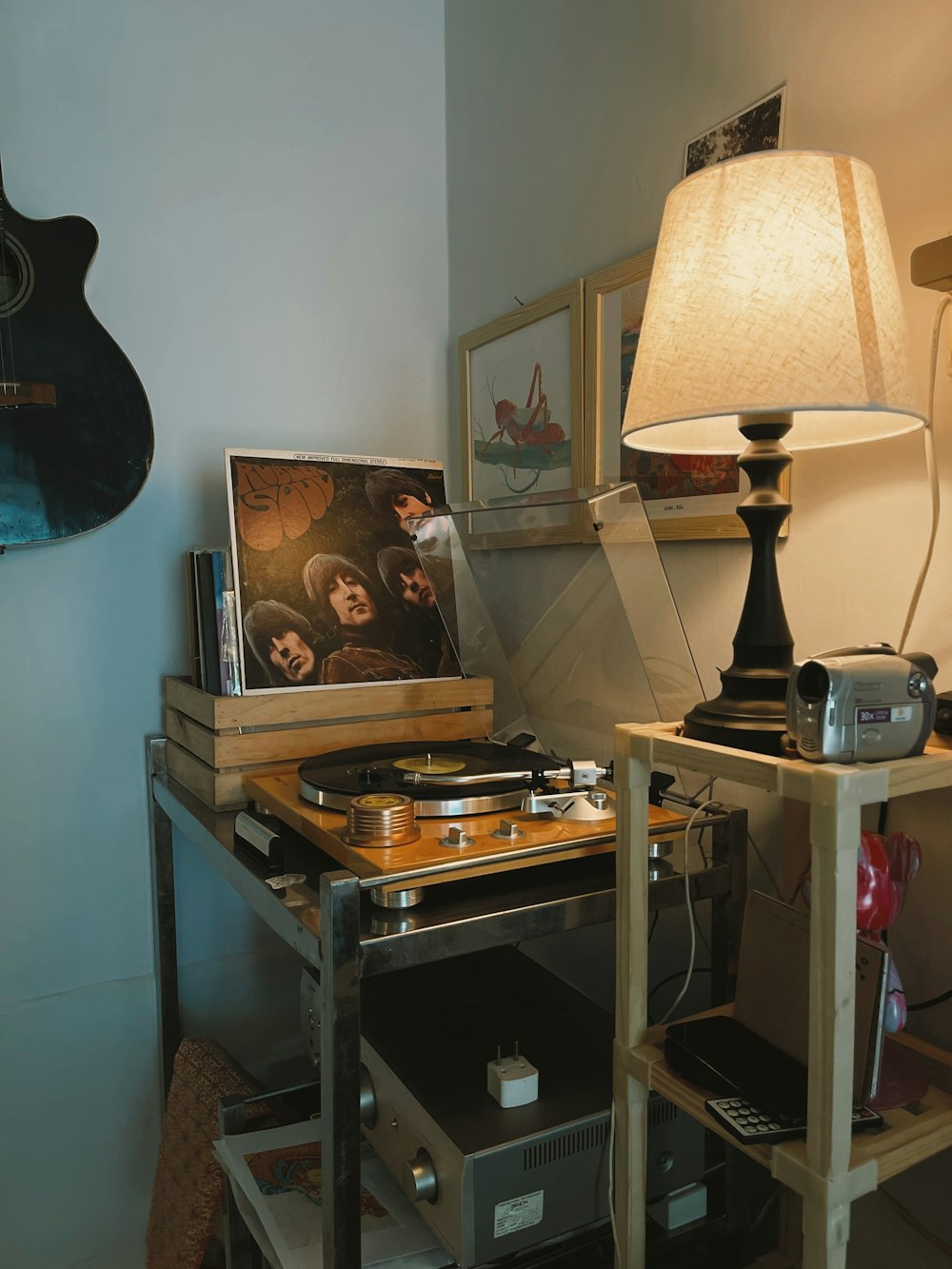 a table with a record player and a lamp