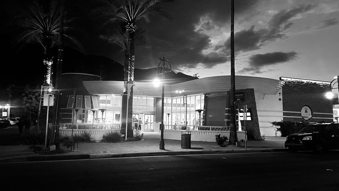 a black and white photo of a building at night,
