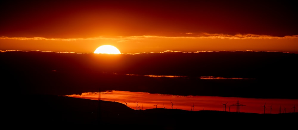 the sun is setting over a body of water