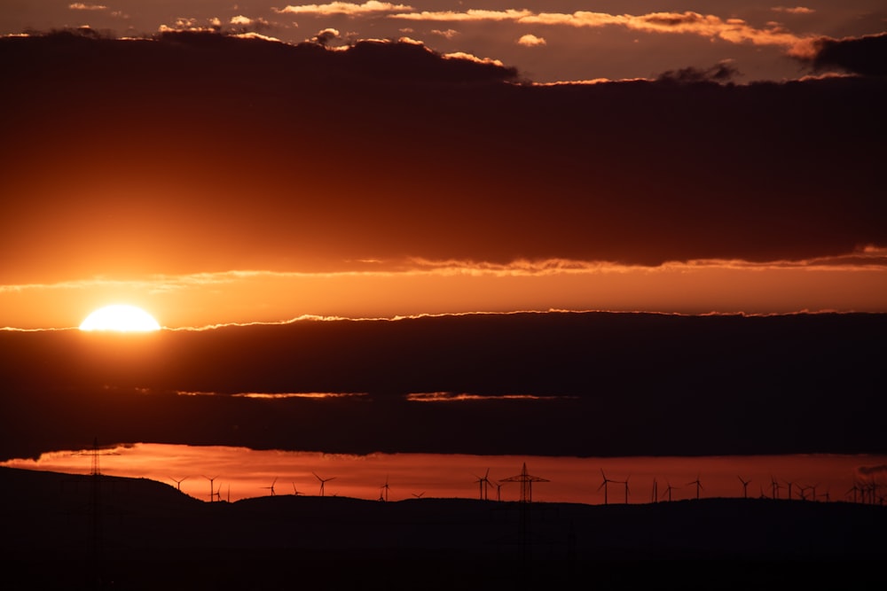 the sun is setting over a large body of water