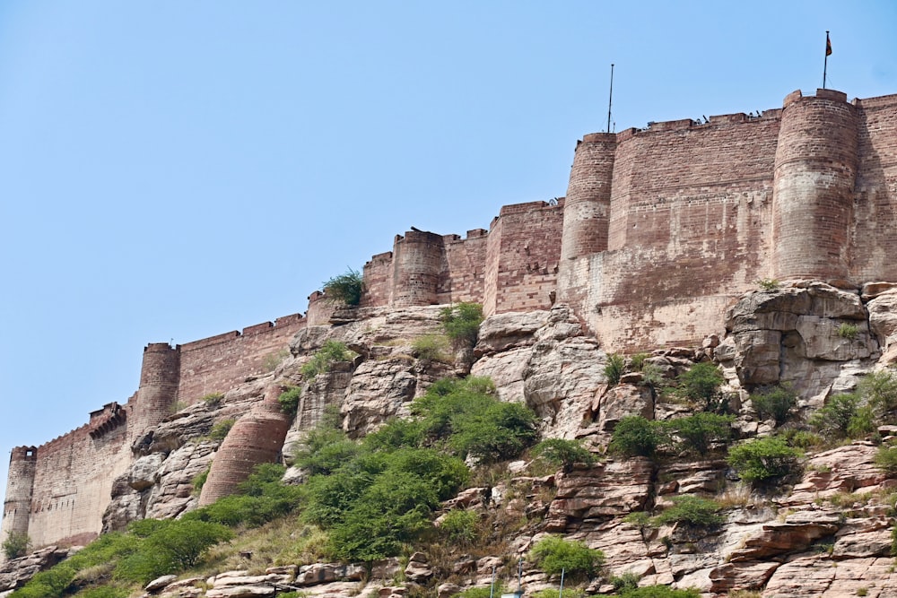 a castle on top of a mountain with a sky background