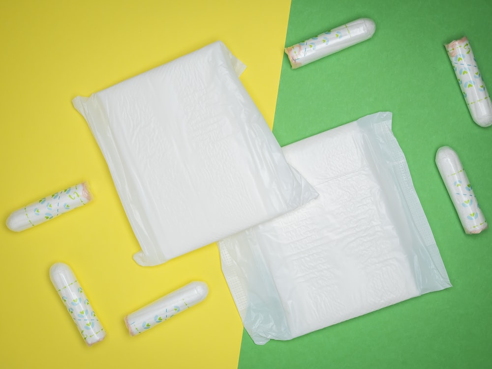 a bag of toilet paper next to a pair of toothbrushes