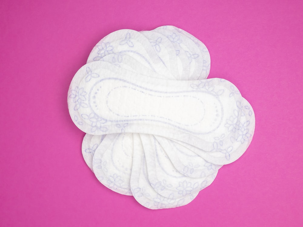 a close up of a cloth pad on a pink background
