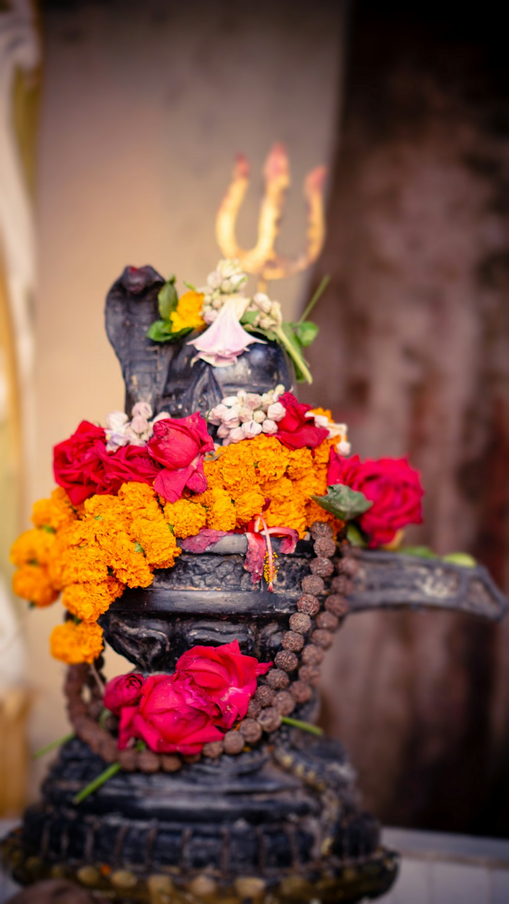 a statue with flowers on top of it