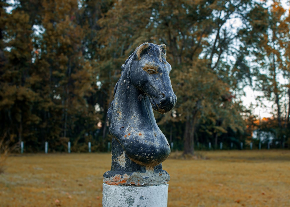 a statue of a horse in a field