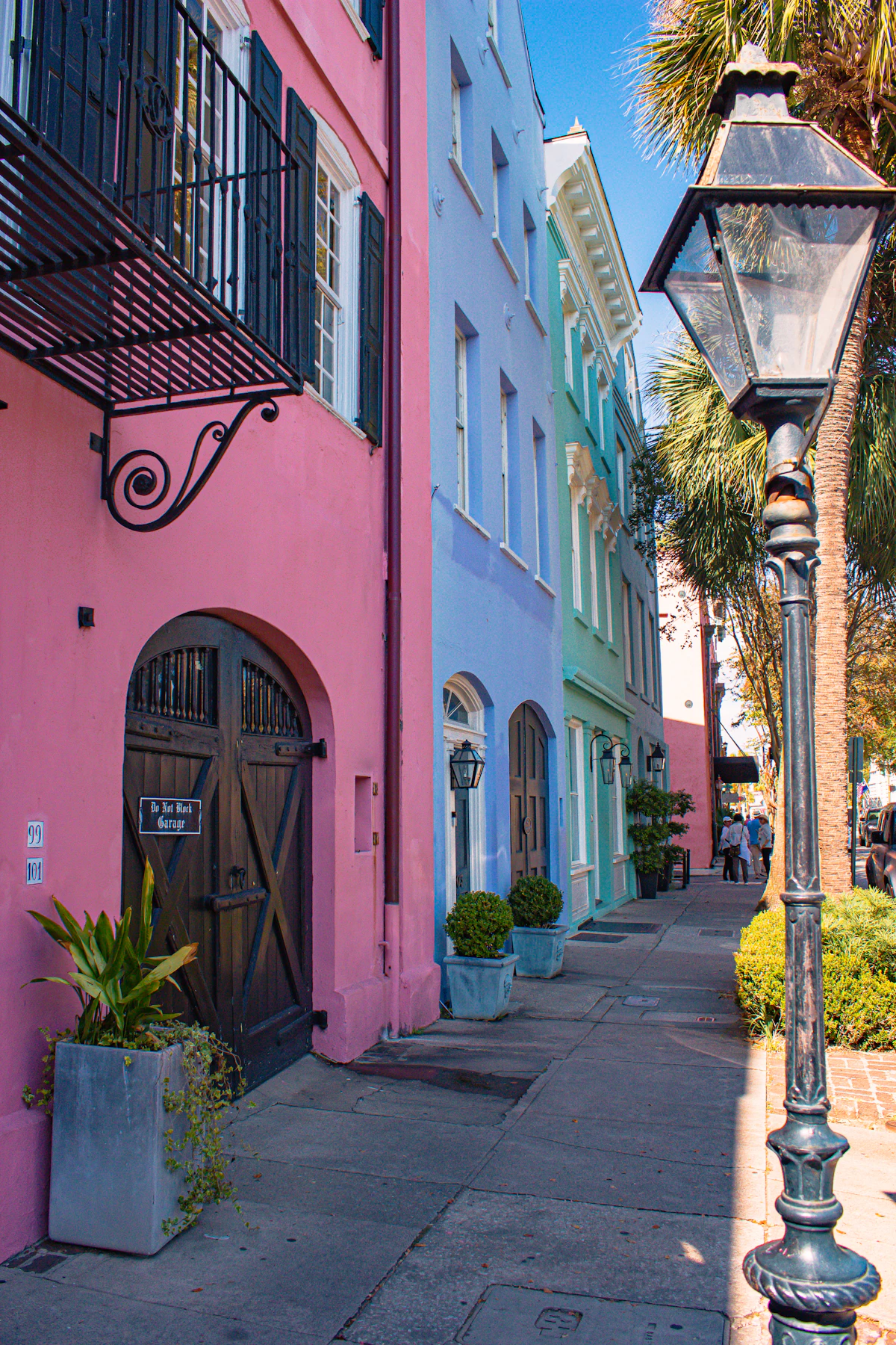 Street lamp beside a pink stucco building in Charleston