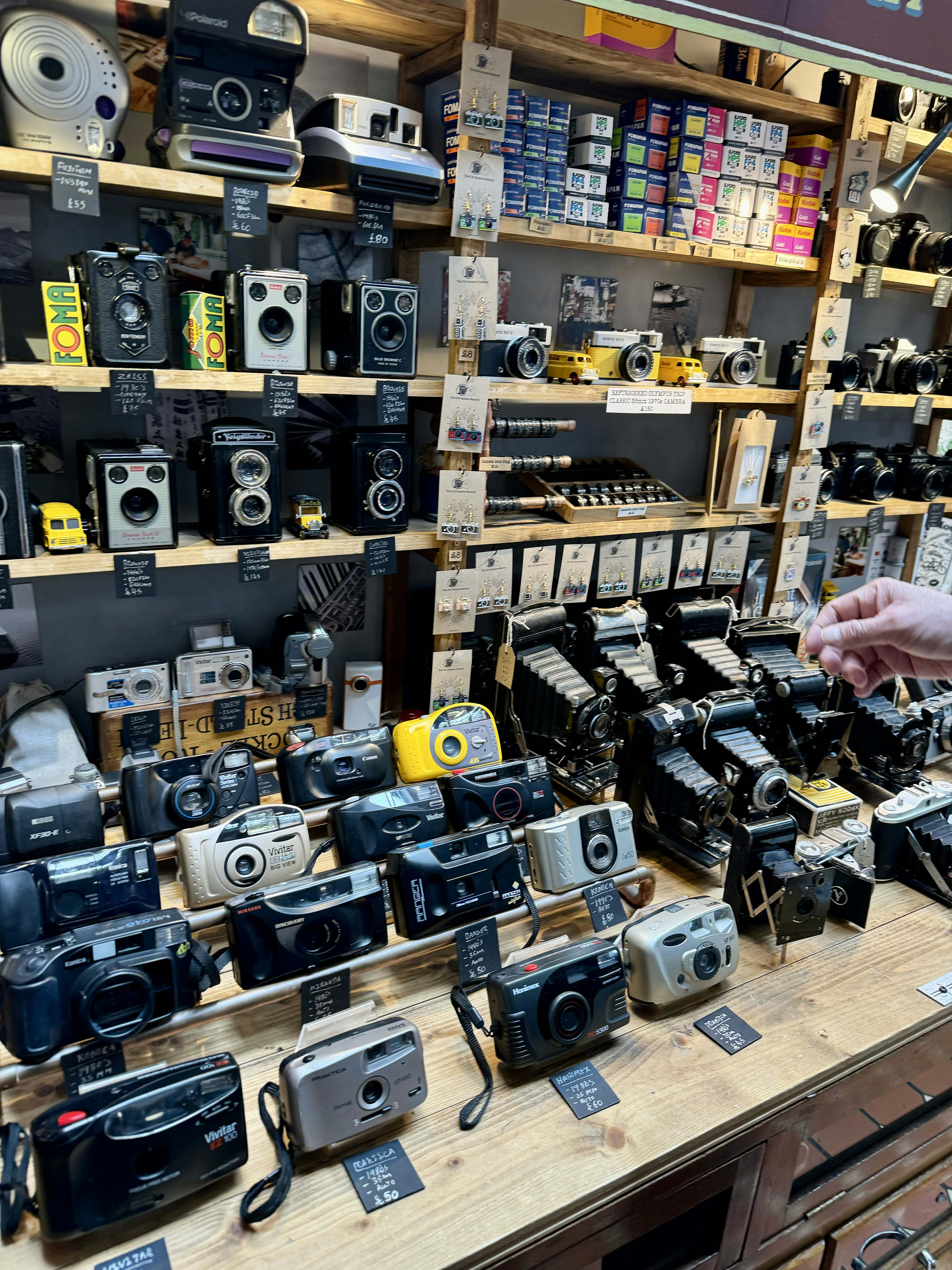 A store display with many different types of cameras photo – Free ...