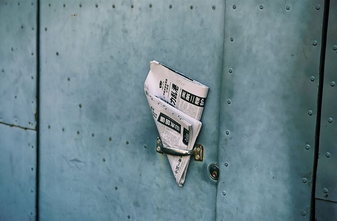 Newspaper left in an industrial door handle in Beijing