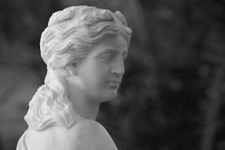 a black and white photo of a statue of a woman