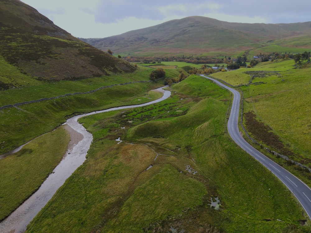 an aerial view of a winding road in the mountains