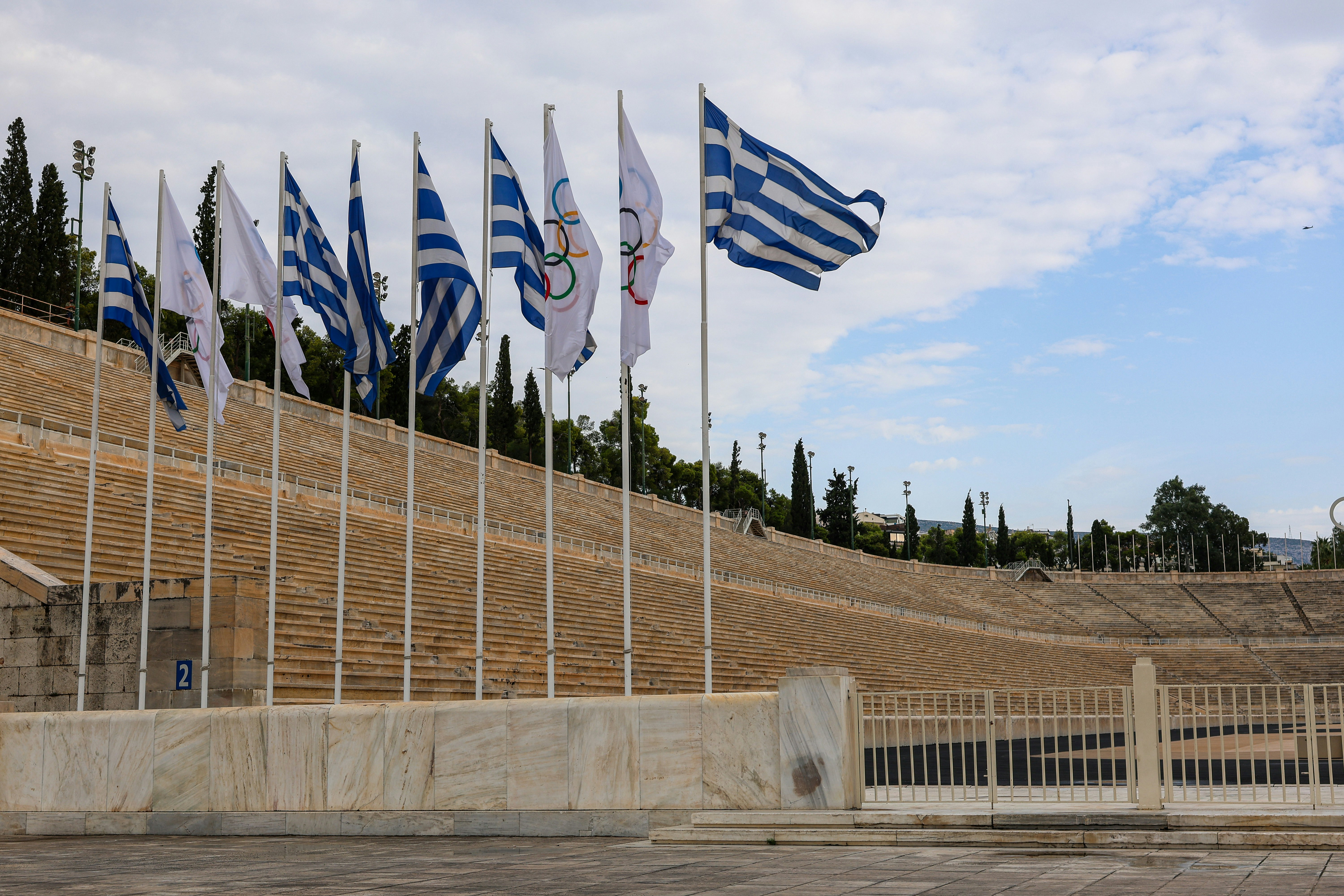 a bunch of flags that are in front of a building