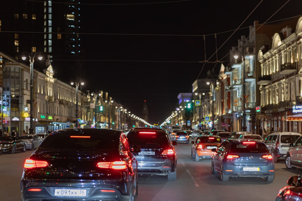 a city street filled with lots of traffic at night