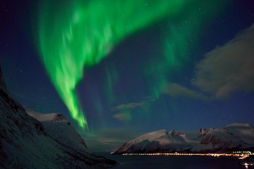 a green and blue aurora bore is in the sky