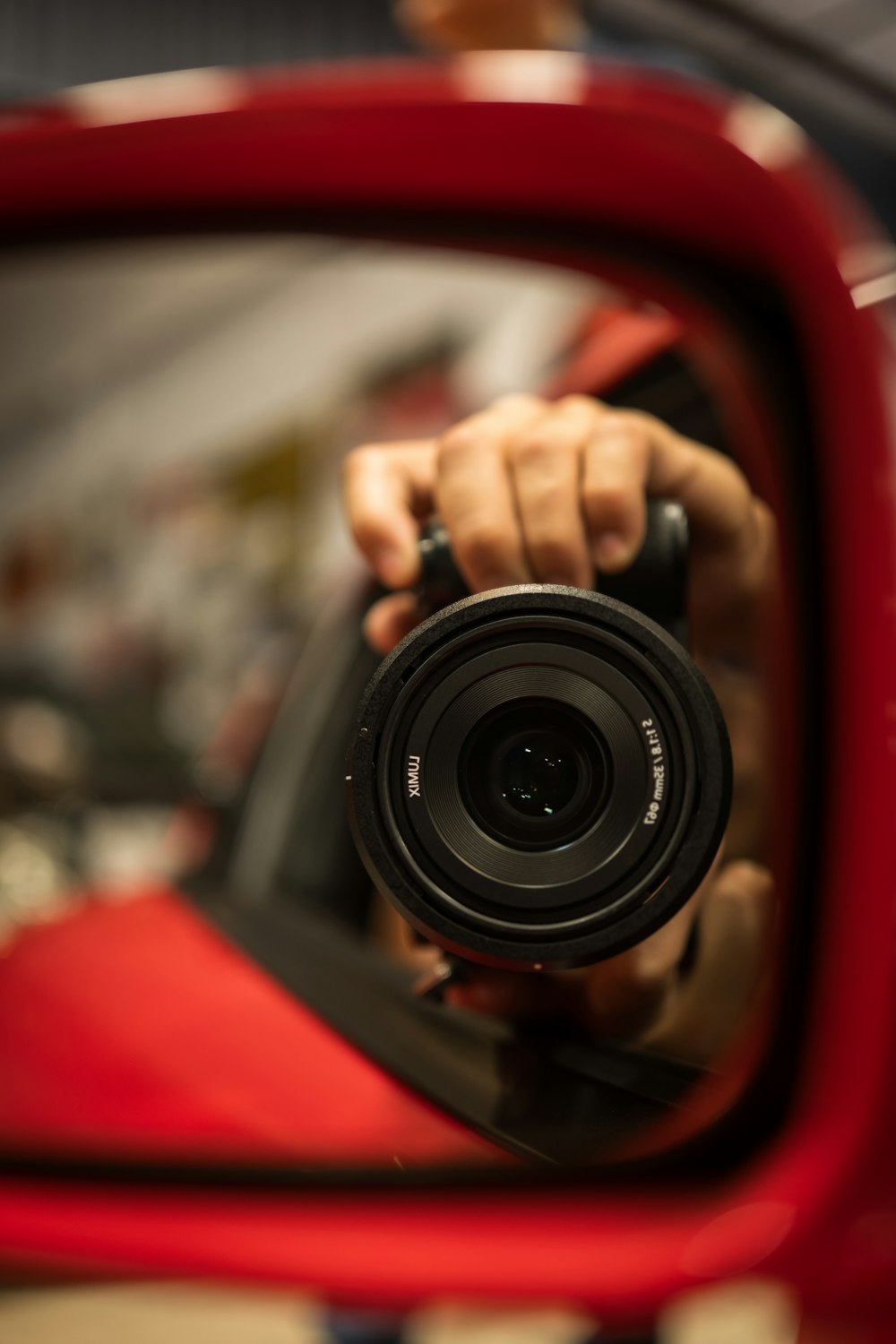 a person holding a camera in front of a mirror