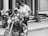 a black and white photo of a man and a woman on a motorcycle