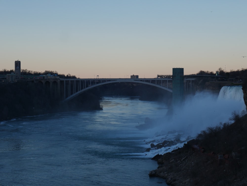 a bridge over a body of water next to a river