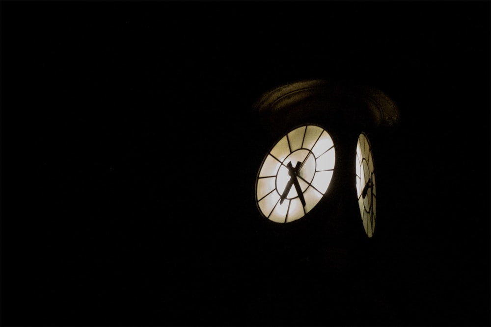 a clock with a person standing in front of it