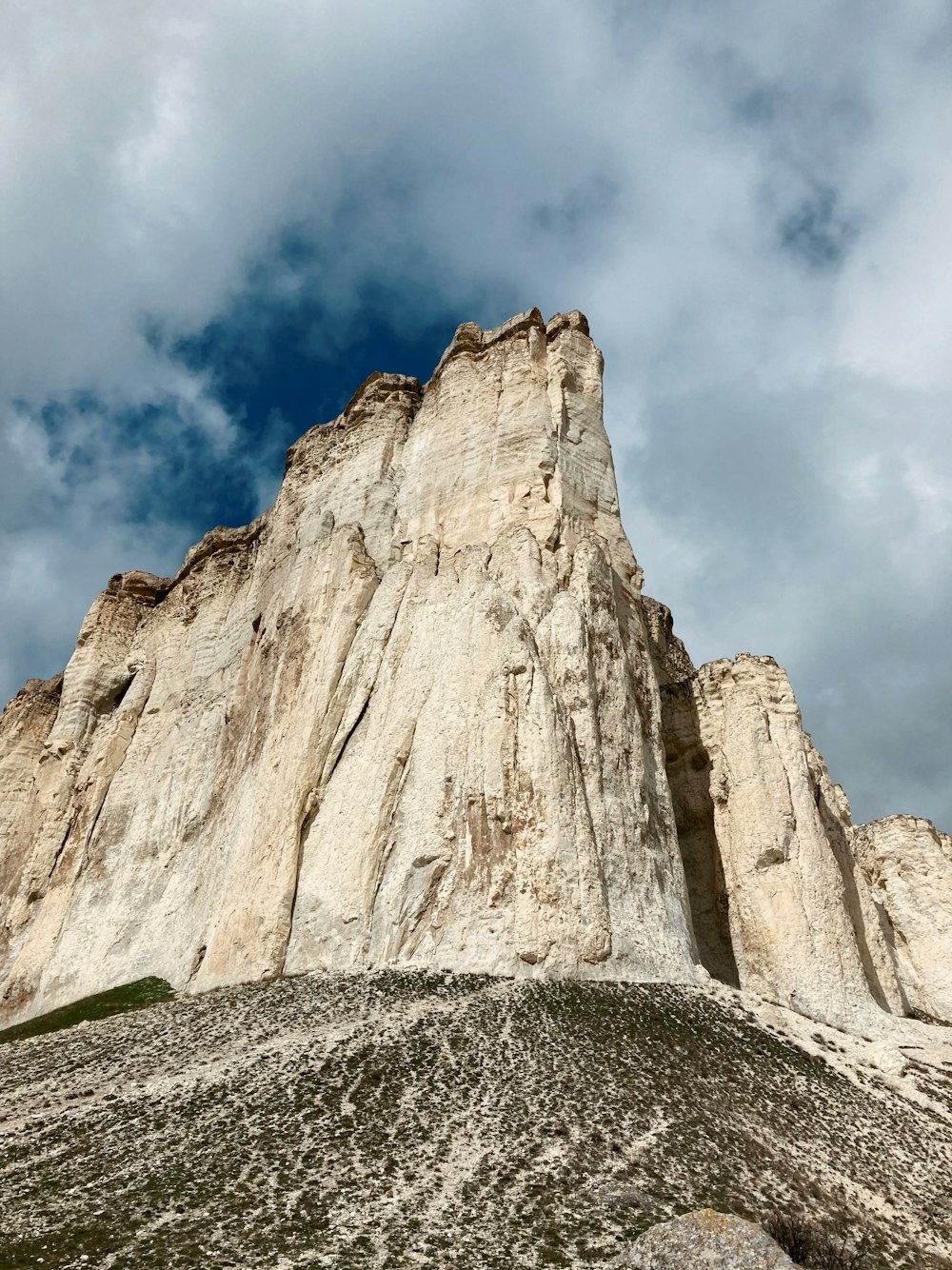 a very tall mountain with a sky in the background