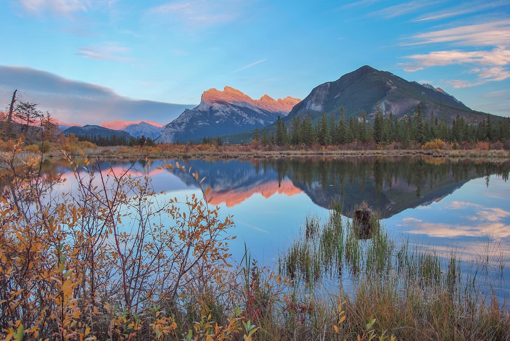 a mountain range is reflected in a lake