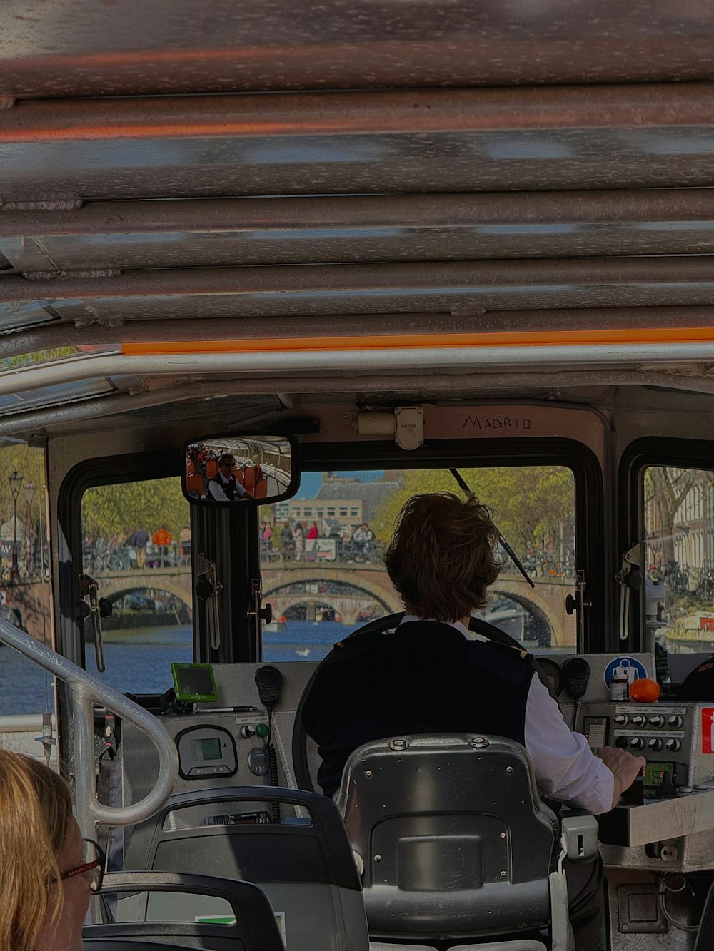 two people sitting on a bus looking out the window