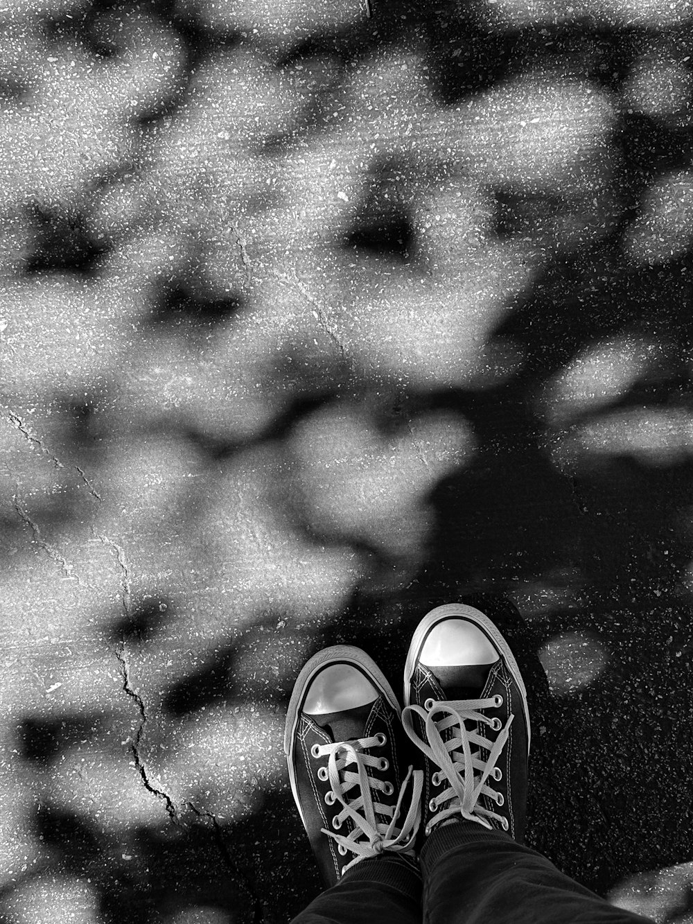 a person's feet with tennis shoes on