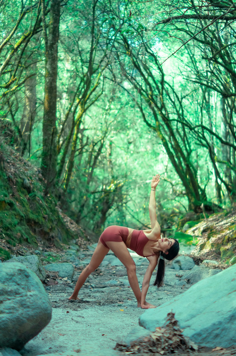 a woman is doing yoga in the woods
