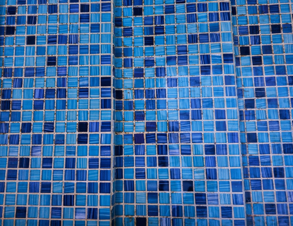 a close up of a blue tiled wall