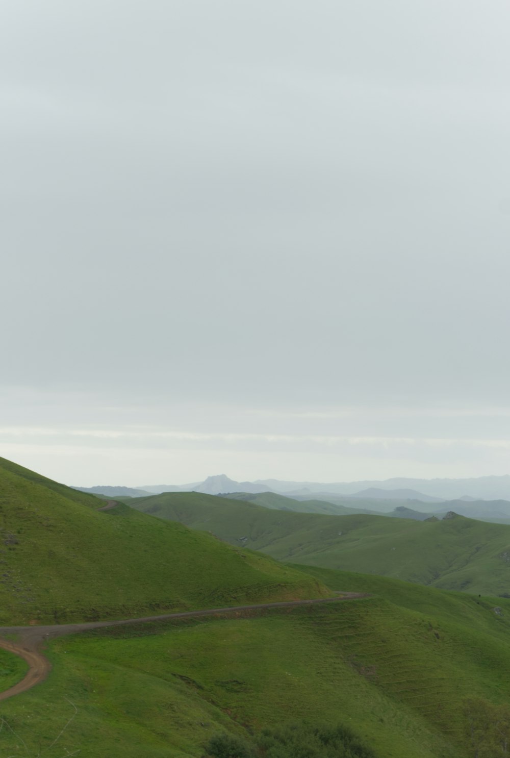 a road going up a hill in the middle of nowhere