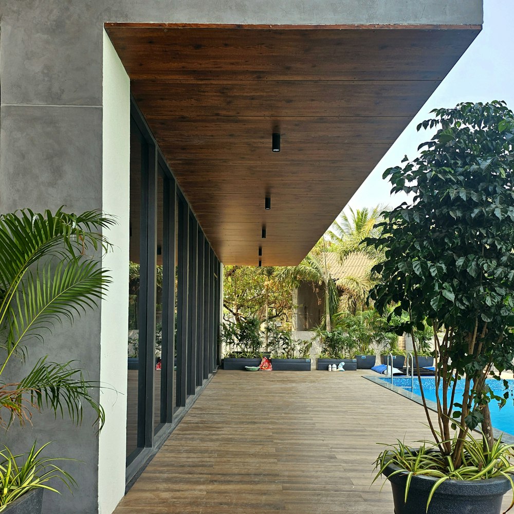 a long wooden walkway leading to a swimming pool