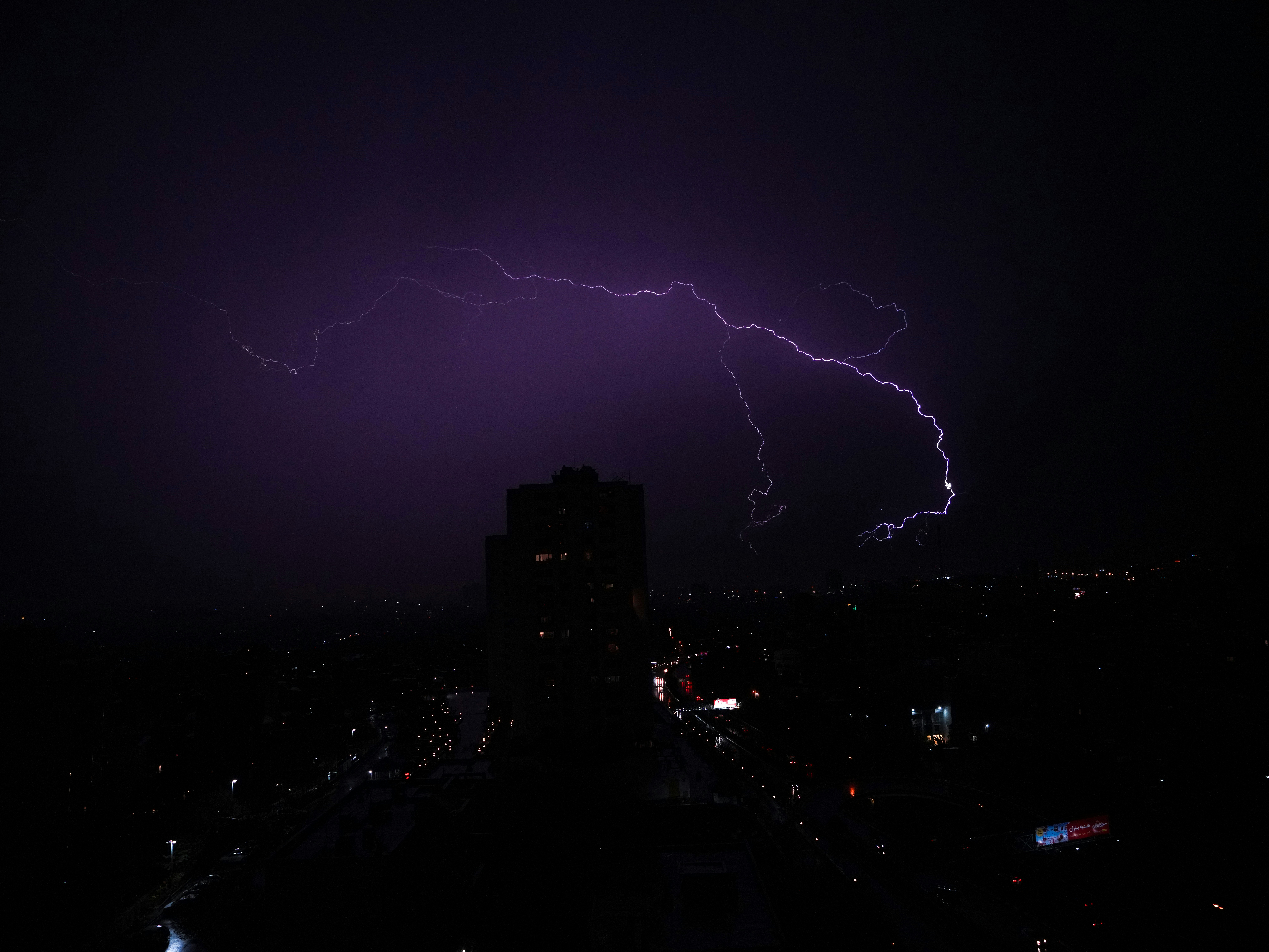 A lightning bolt strikes over a city at night photo – Free Blue Image ...