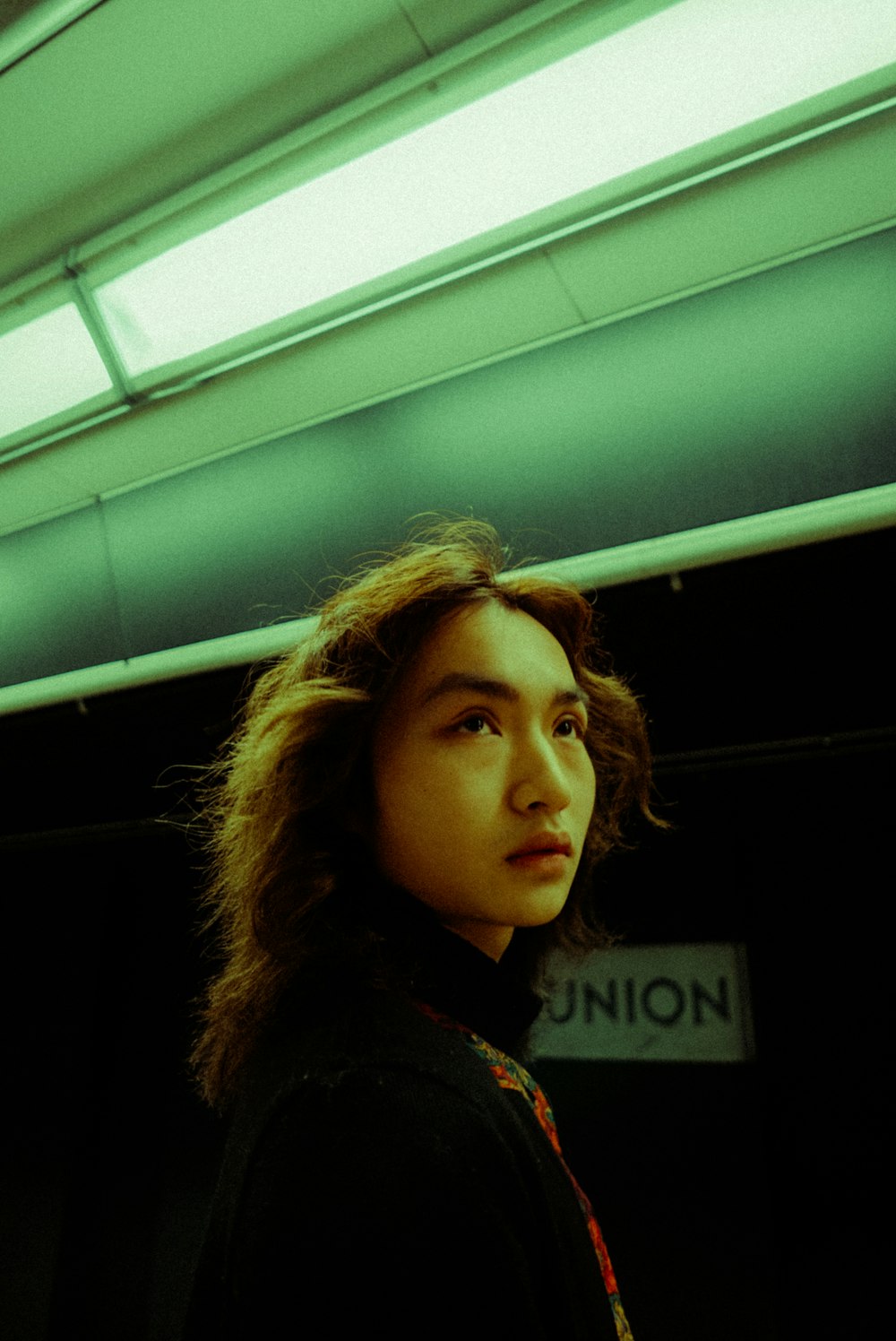 a woman is standing in a subway station