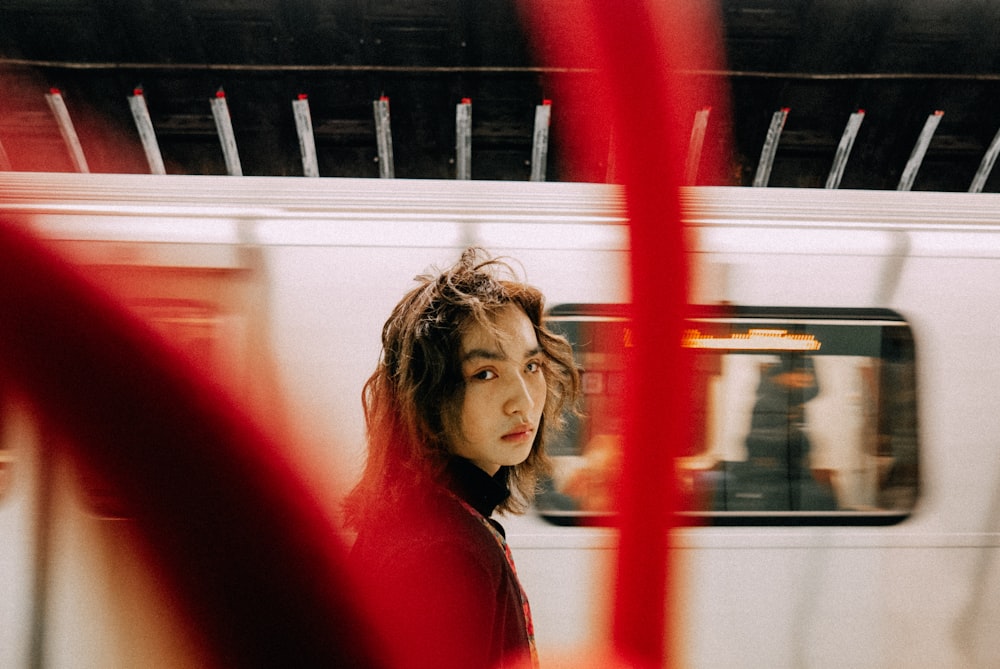 a woman standing in front of a train