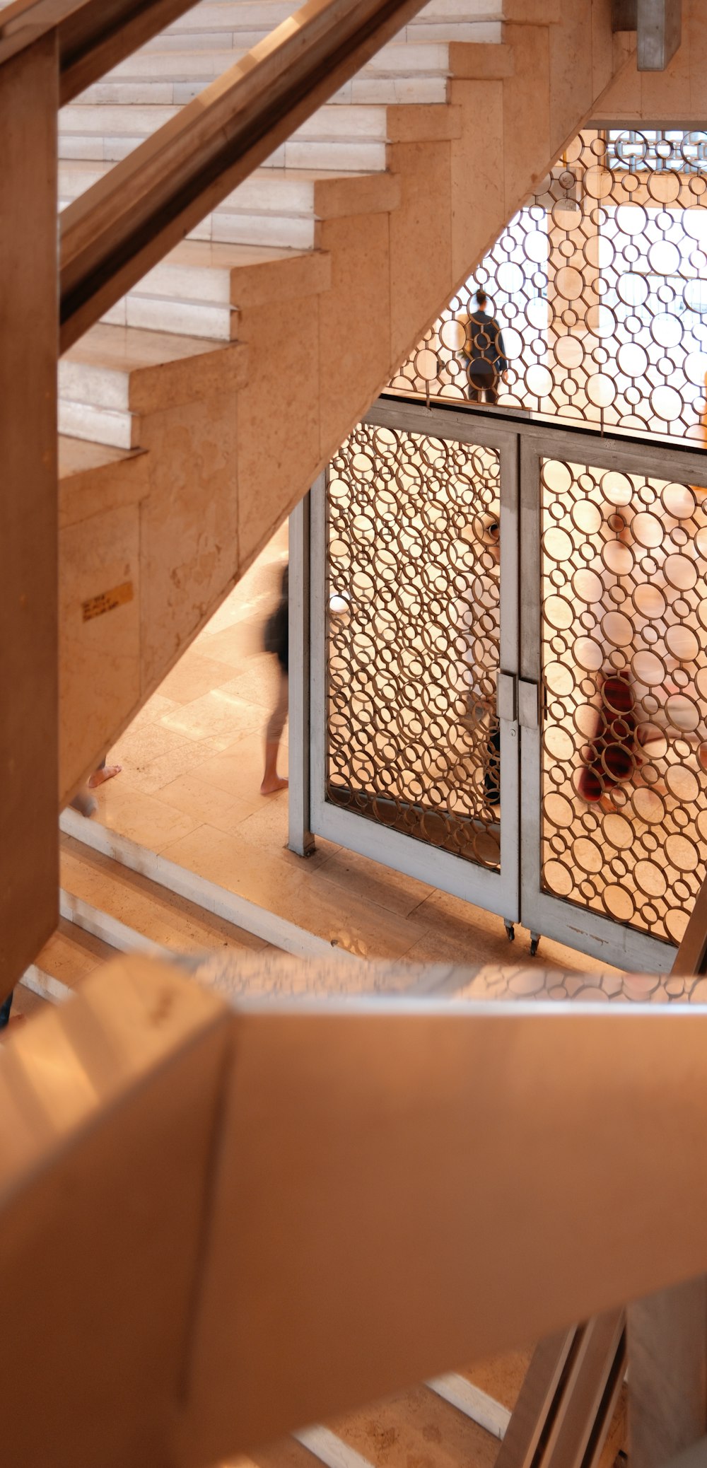 a group of people walking up and down a set of stairs