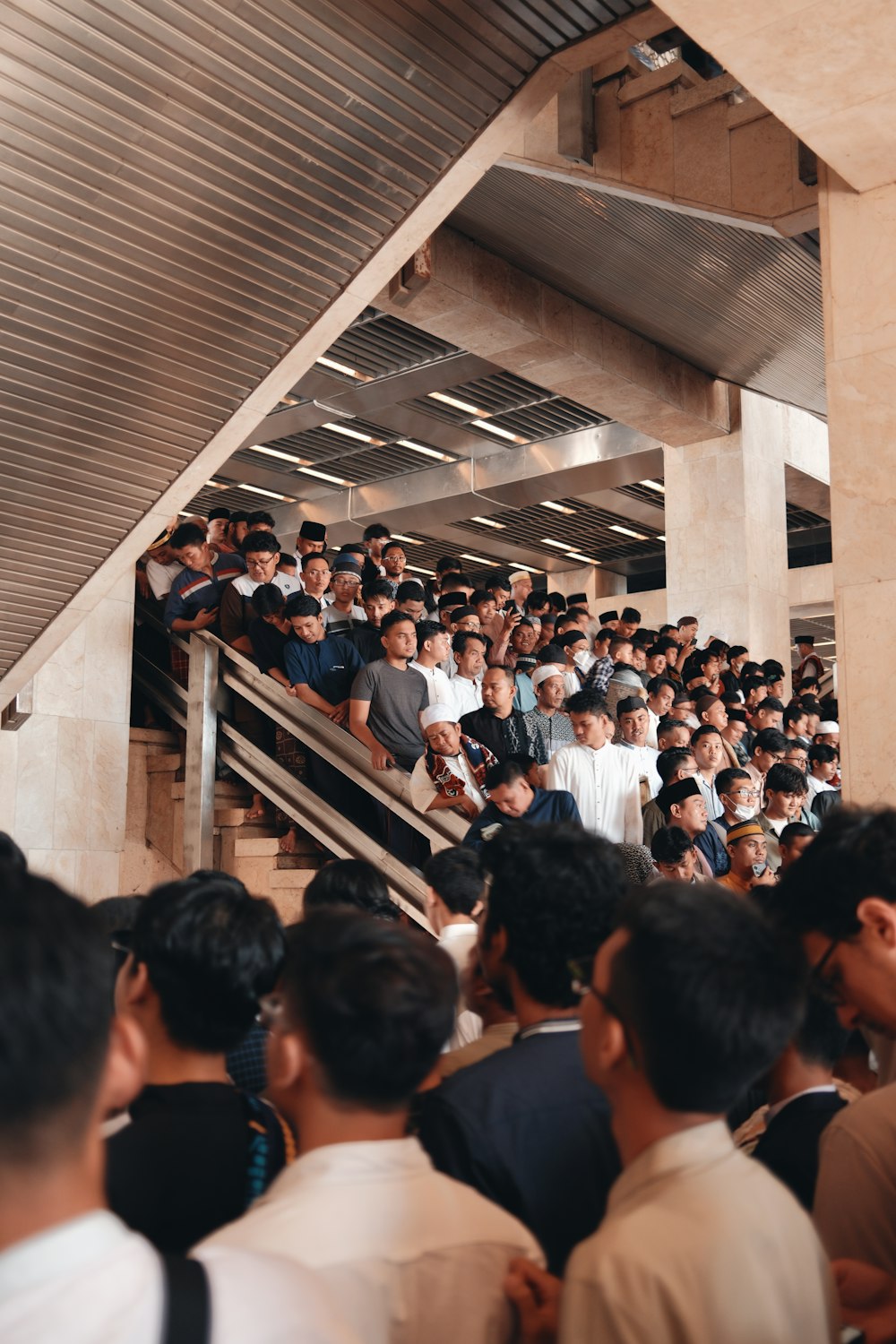 a crowd of people standing around a staircase