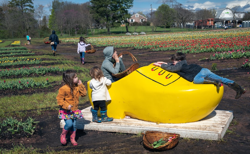 a group of people standing around a large banana shaped object