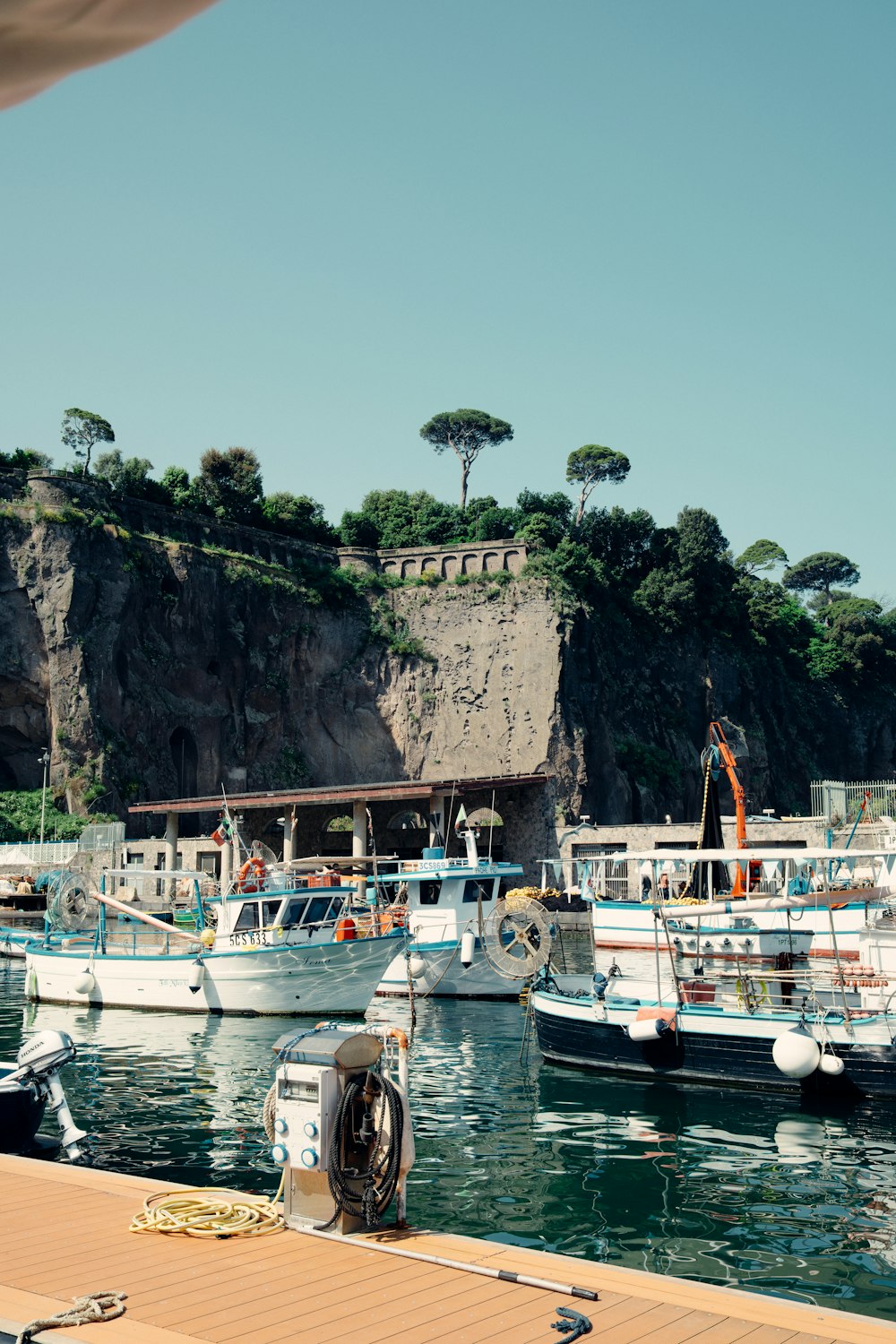 a group of boats are docked at a pier