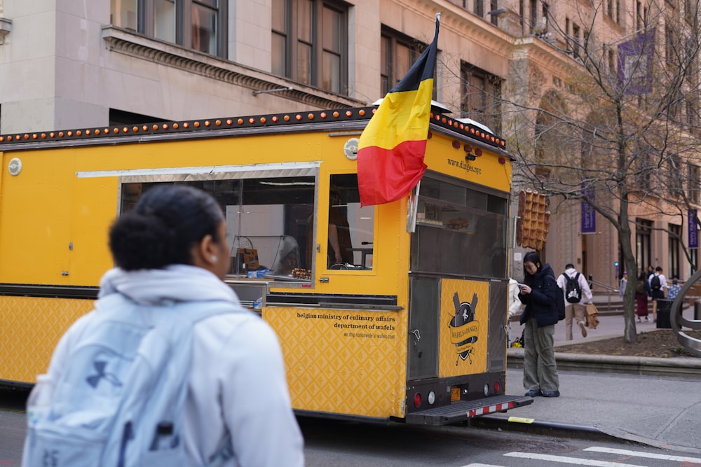 a yellow food truck with a german flag on it