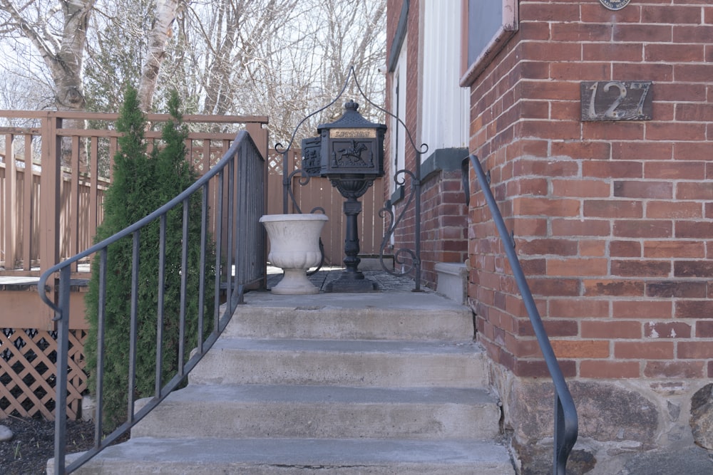 a stair case with a urn on the side of it