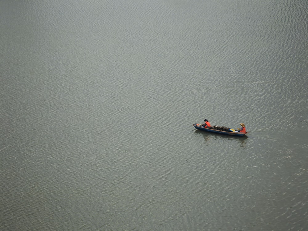 a small boat floating on top of a large body of water