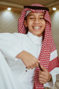 a young man wearing a red and white scarf