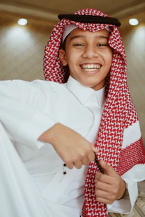 a young man wearing a red and white scarf