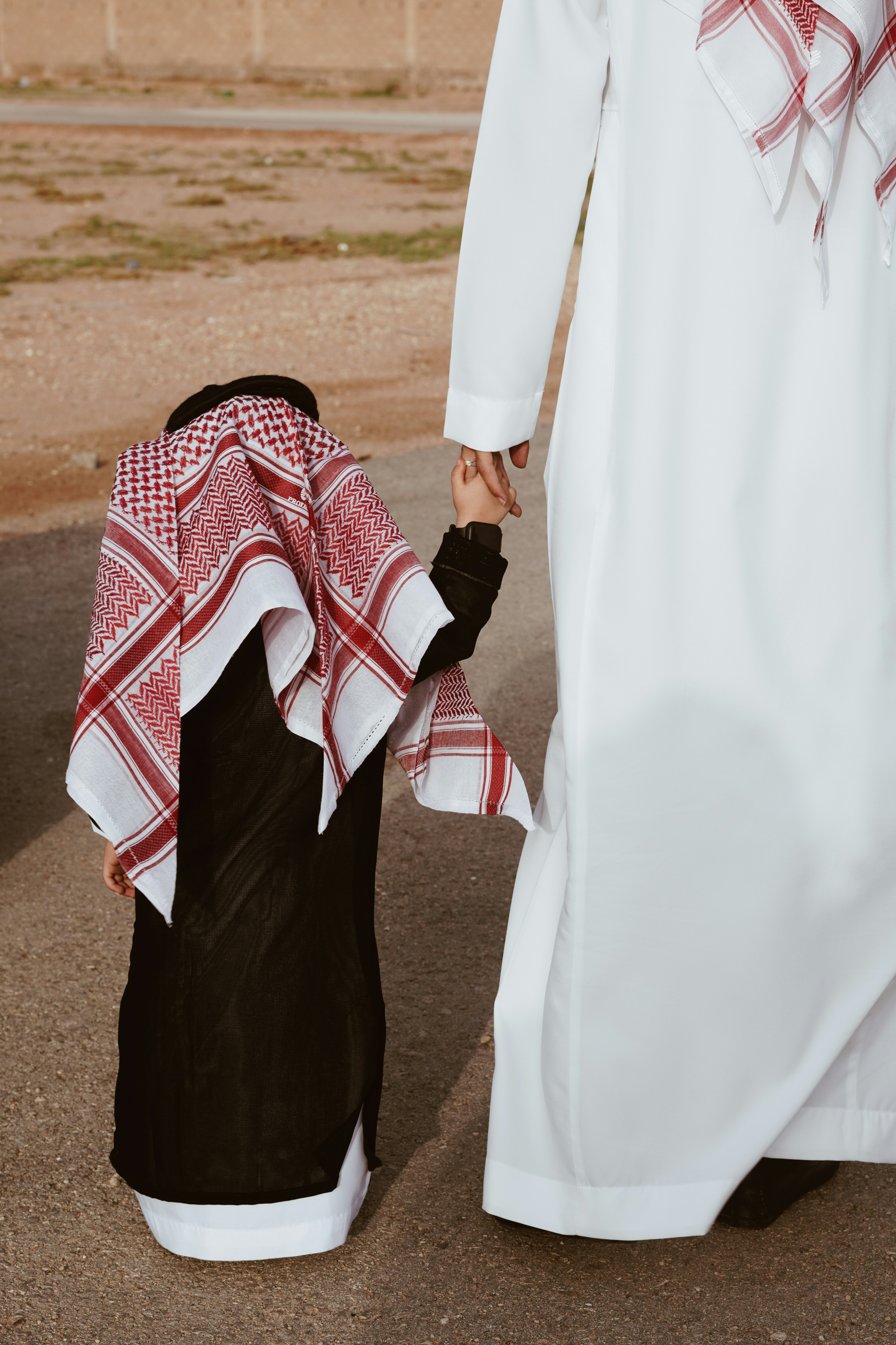 a person holding the hand of a person in a white dress