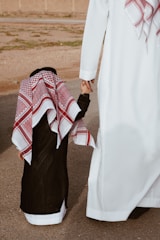a person holding the hand of a person in a white dress