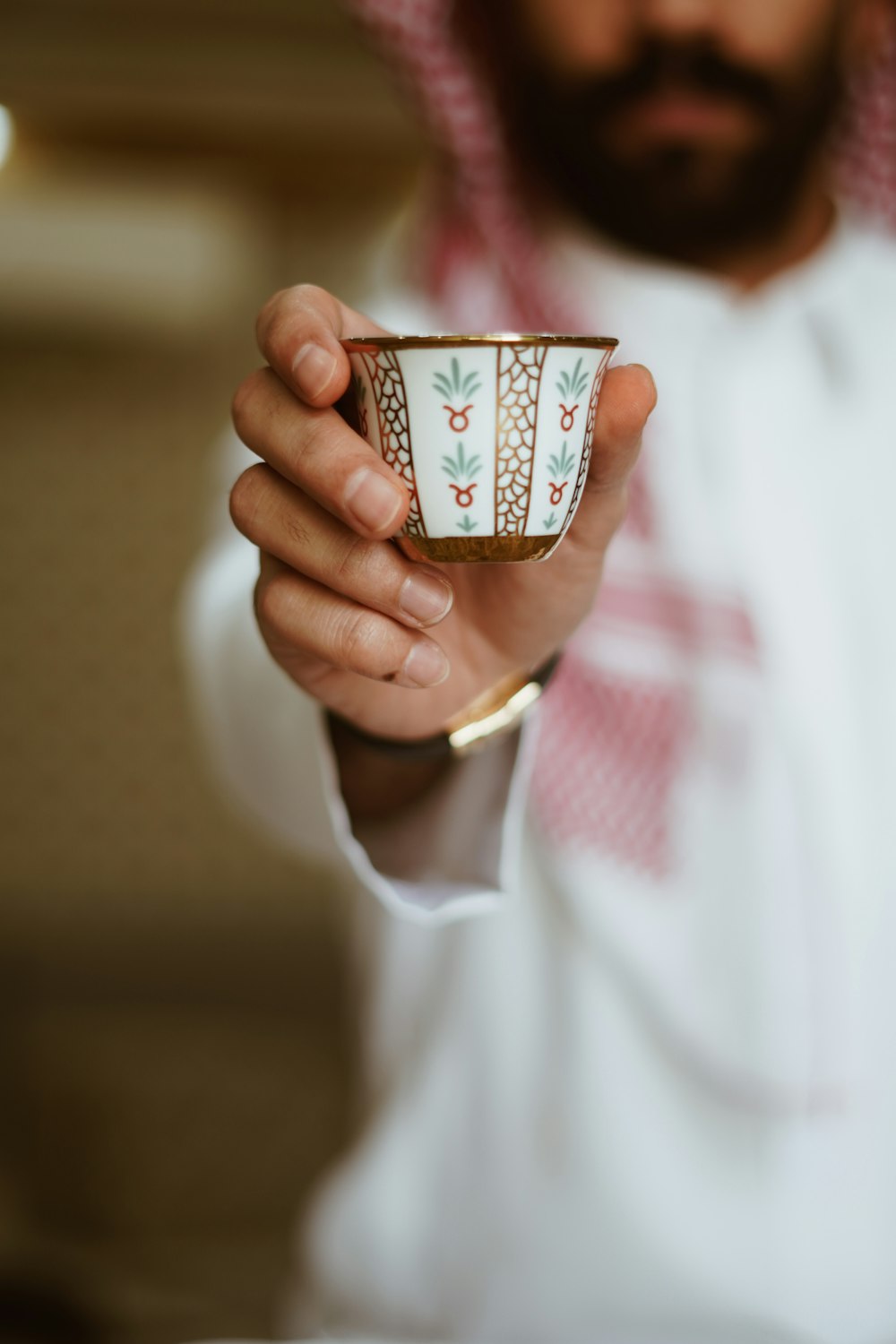 a man holding a cup in his hand