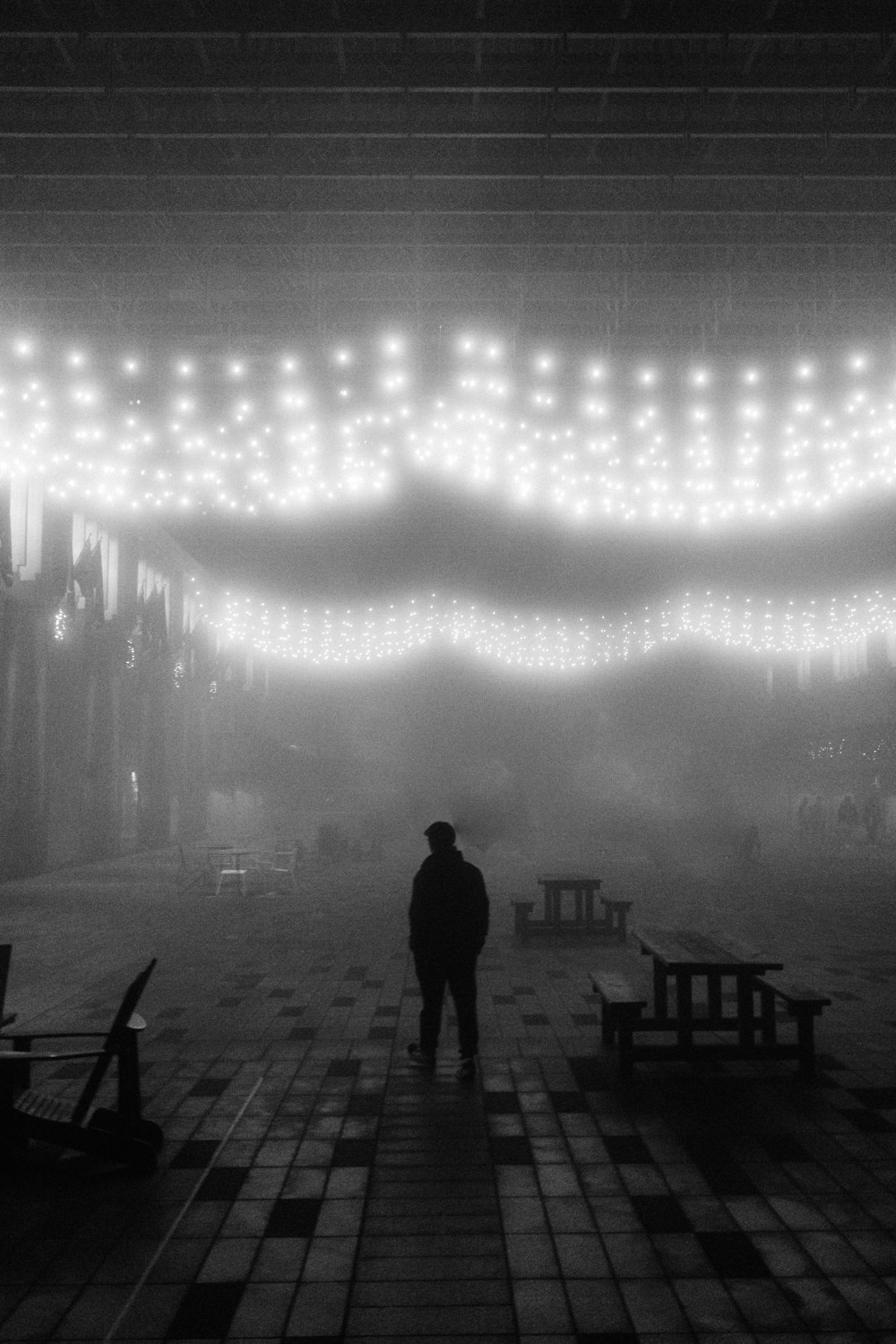 a man standing in front of a stage with lights