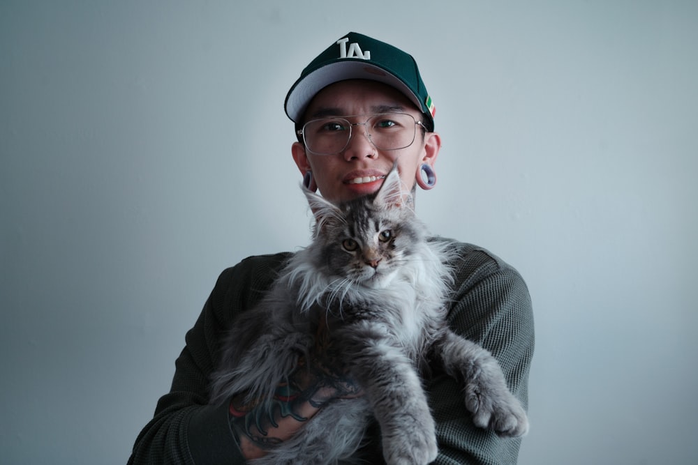 a man holding a cat in his arms