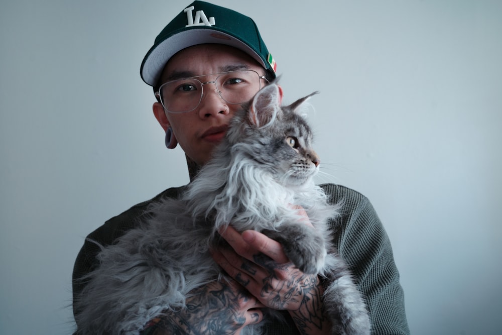 a man holding a cat in his arms