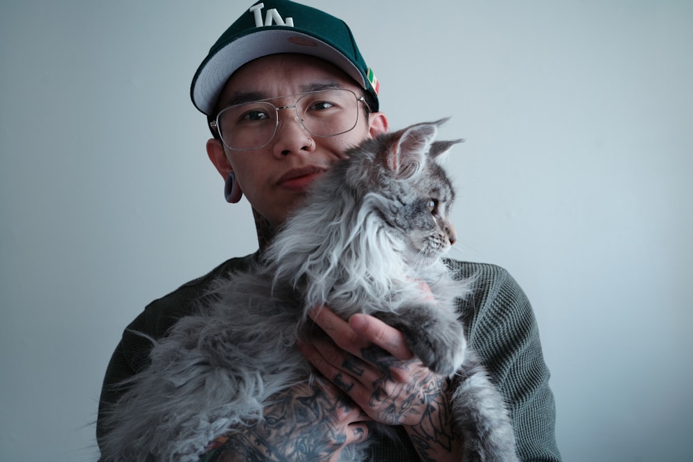 a man holding a cat in his arms