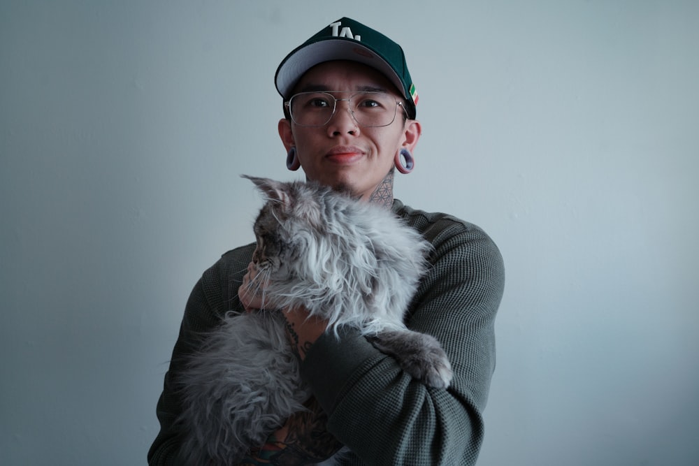 a woman holding a cat in her arms